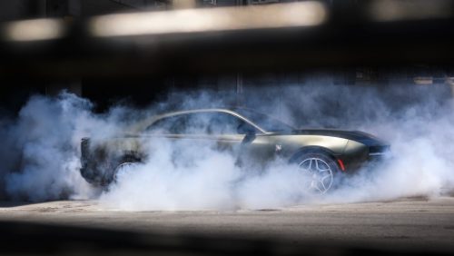 Un Dodge Charger Scat Pack 2027 plateado de perfil, con humo alrededor del coche.