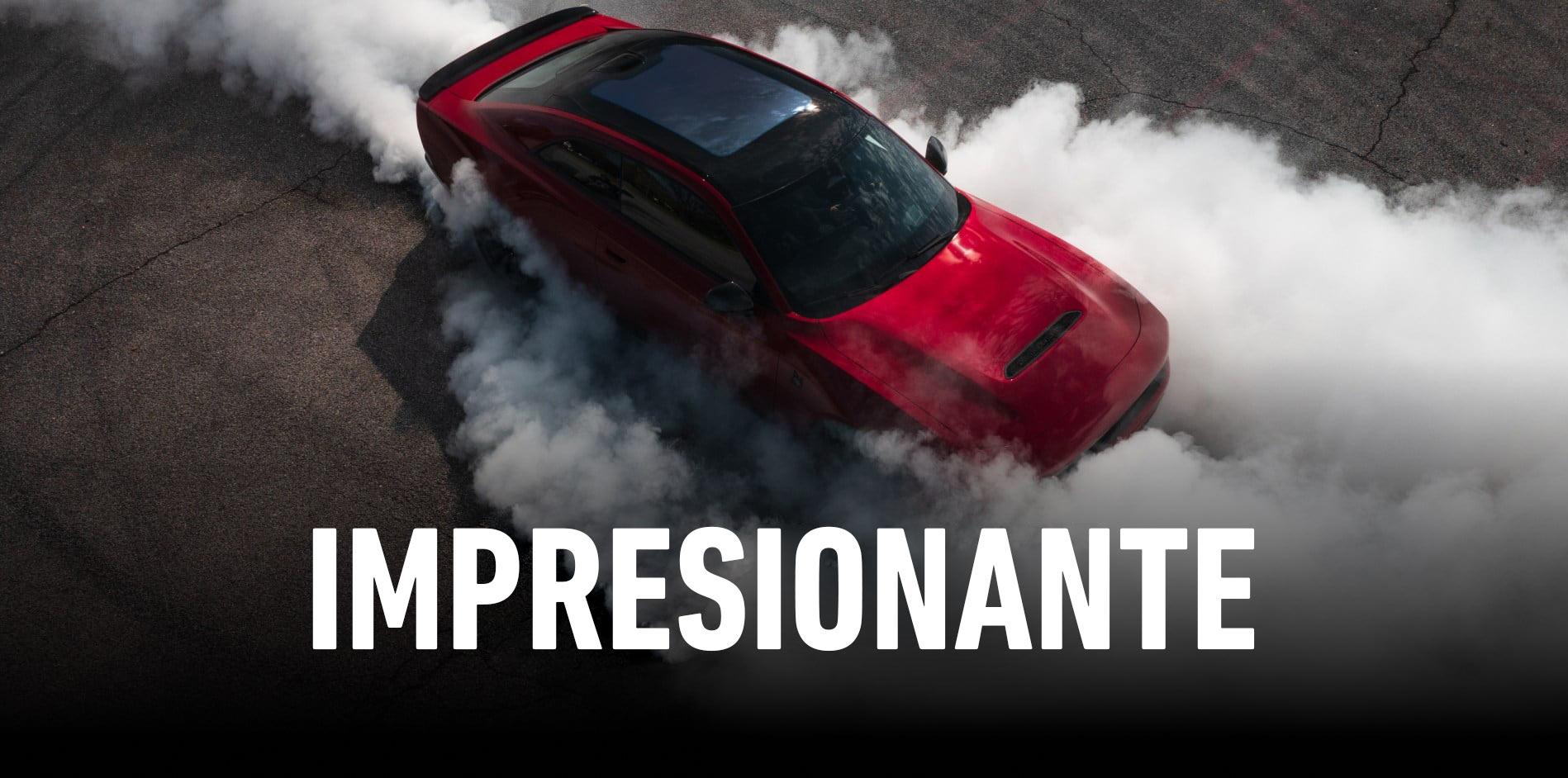 Un Dodge Charger Scat Pack 2027 rojo con techo de vidrio, rodeado de humo que sale de sus neumáticos, tomado desde arriba. Impresionante.